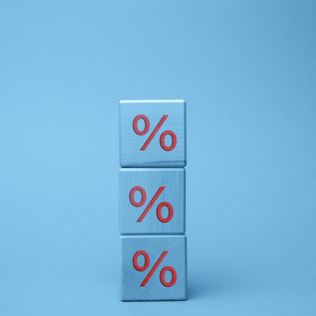 wooden blocks with percent on a blue background. The concept of reducing or increasing prices, rates on depositsの写真素材