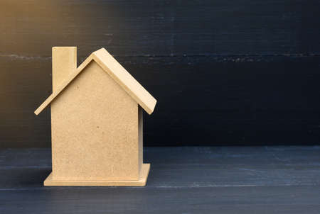 wooden house on a blue background. Real estate rental, purchase and sale concept. Realtor services, building repair and maintenance, copy spaceの写真素材