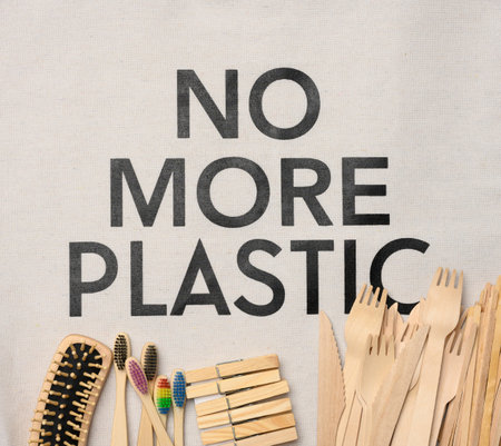 toothbrush, comb, clothespin and other wooden items on a white background, top view, no more plastic