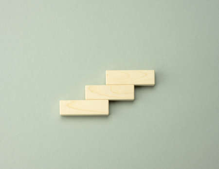 three wooden cubes in the form of steps up. The concept of achieving business goals, personal...