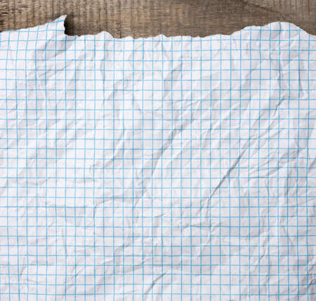 crumpled white paper texture in a cage, blue lines, school notebook