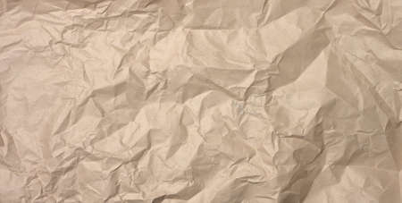 crumpled blank sheet of brown wrapping kraft paper, vintage texture for the designer, full frame, bannerの写真素材
