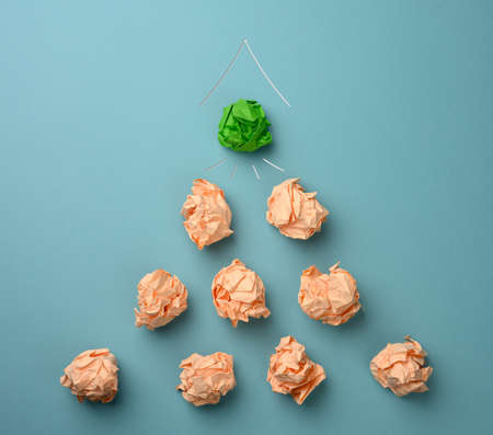 crumpled sheets of colored paper on a blue background. Solution concept, brainstorming, leap forward, top viewの写真素材