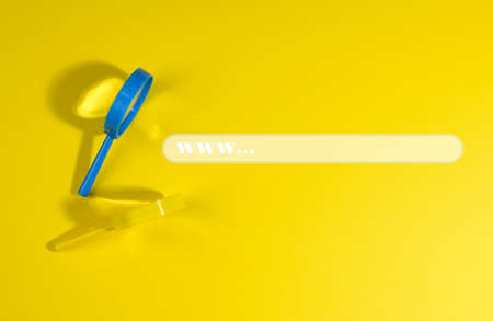 plastic magnifiers and a form for searching information on the Internet, yellow background