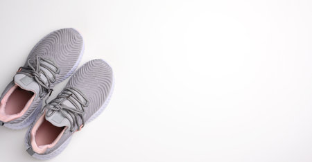 pair of gray textile sneakers on a white background, top view. Shoes for sports, joggingの写真素材
