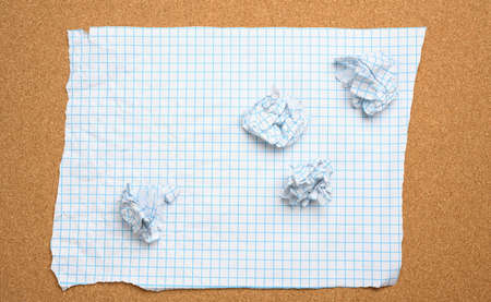 blank crumpled white sheet of paper in a cage and crumpled balls, top viewの写真素材