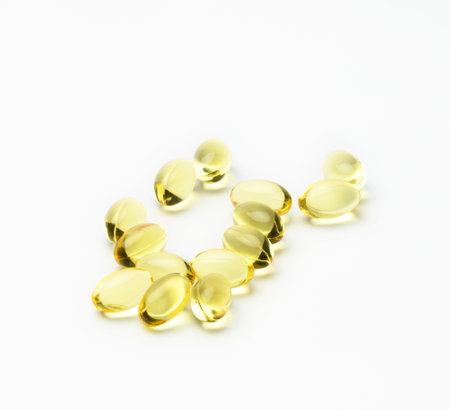 fish oil capsules on white background, food supplement for health, close upの写真素材