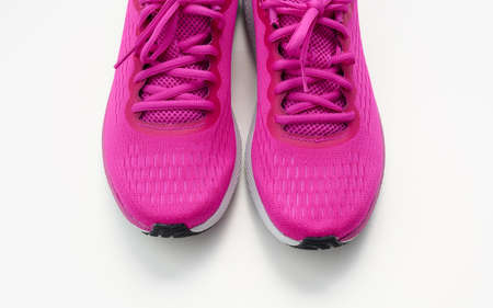pair of purple textile sneakers on a white background, top view. Shoes for sports, jogging