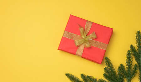 redngift box tied with ribbon on a gray background, top view. Festive backdrop