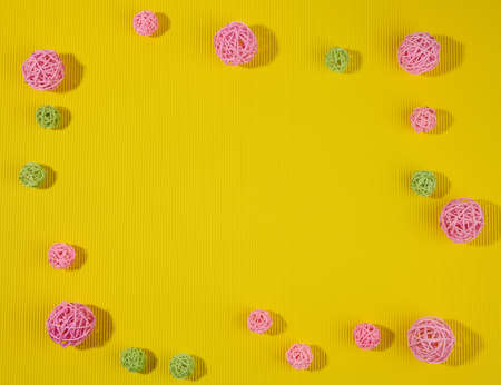 abstract green background with pink and green wicker balls, top view, copy spaceの写真素材