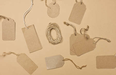 blank brown rectangular, round brown paper tag on a rope isolated on white background, template for price, discountの写真素材