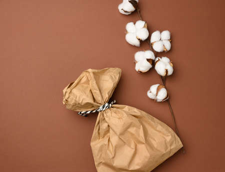 full brown paper disposable food bag on a beige background, concept of delivery and ordering, top view, zero wasteの写真素材