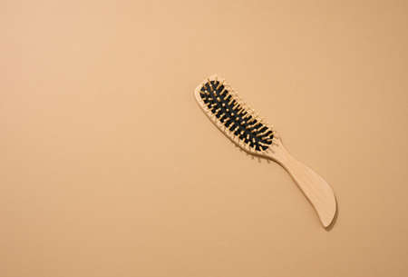 wooden hair comb on brown background, zero waste. Top viewの写真素材