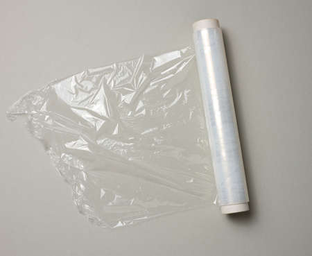 roll of transparent cling film for packaging ona gray background, top viewの写真素材
