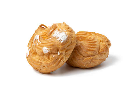 two baked round eclairs on a white backgroundの写真素材