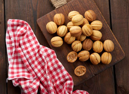 baked dessert nuts with condensed milk on a wooden board, top view