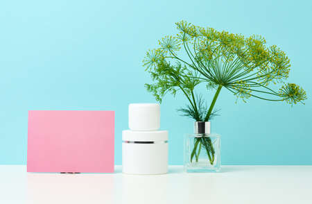 empty white plastic tube and jar for cosmetics. Packaging for cream, gel, serum, advertising and product promotion, mock upの写真素材