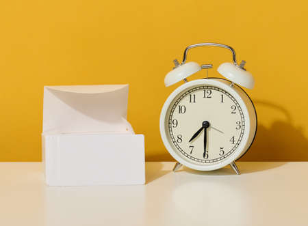 stack of white rectangular business cards on a yellow background, company branding, address.の写真素材