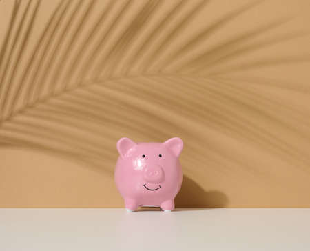 ceramic pink piggy bank on a brown background. Concept of increasing income from bank accounts, savingsの写真素材