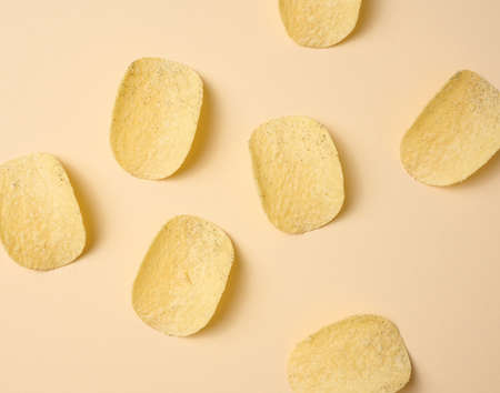 round potato chips on a beige background, top viewの写真素材