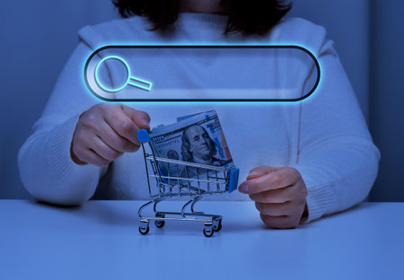 woman holds a metal tedeku with paper american dollars and a line for entering information search, online shopping, inquiryの写真素材