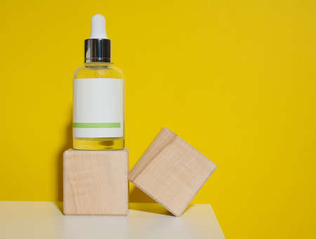 white glass bottle with a pipette and a empty white label. Container for cosmetics, serum and oil. Mockup skincare productの写真素材
