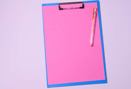 blue holder with clean pink sheets on a purple background, top viewの写真素材
