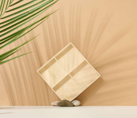background to showcase products, cosmetics, drinks and food. Beige background with shade from palm...
