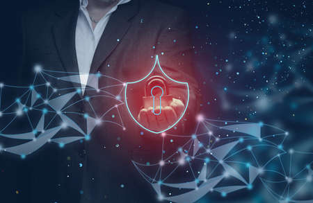 businessman in a suit holds a metal padlock on an abstract background of lines and dots. The concept of protecting personal data on the network, cyber security. Reliable data encryptionの写真素材