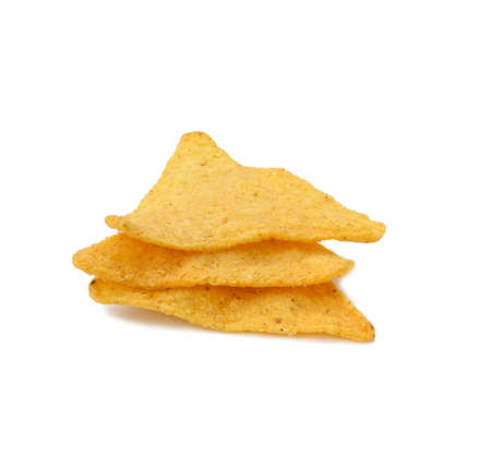 stack of triangular nachos on white backgroundの写真素材