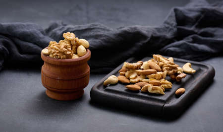 walnut, almond, cashew on a wooden board. Delicious nutritious snackの写真素材