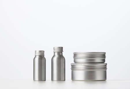 empty silver metal bottle for cosmetics on white table. Packaging for cream, gel, serum, advertising and product promotion. Mock upの写真素材