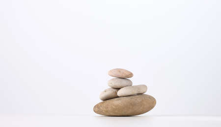 stack of round stones on a white background. Scene for demonstration of cosmetic products, advertisingの写真素材