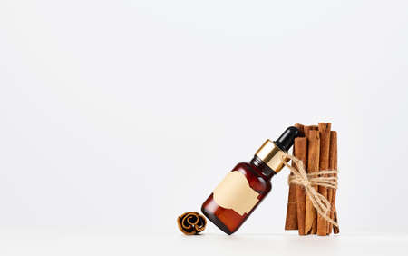 brown glass bottle with paper empty label and pipette. Cosmetic packaging, advertising and promotion