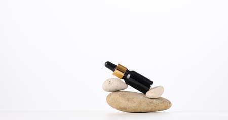 brown glass bottle with a pipette on a white background. Template for cosmetic liquid products, advertising and promotion, copy spaceの写真素材