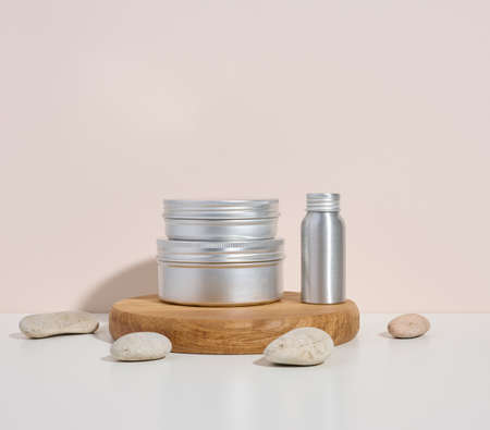 empty silver metal bottle for cosmetics on white table. Packaging for cream, gel, serum, advertising and product promotion. Mock upの写真素材