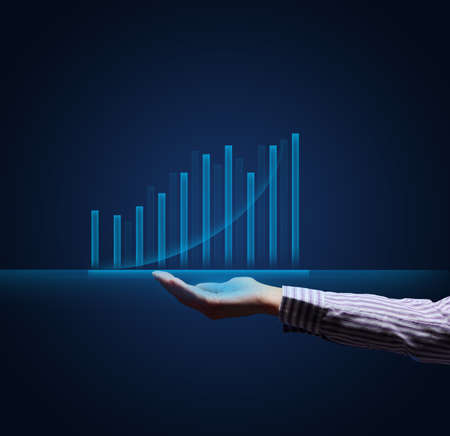 holographic graph with growing indicators and a woman's hand. Business growth concept, profitable startup, profitable business strategyの写真素材