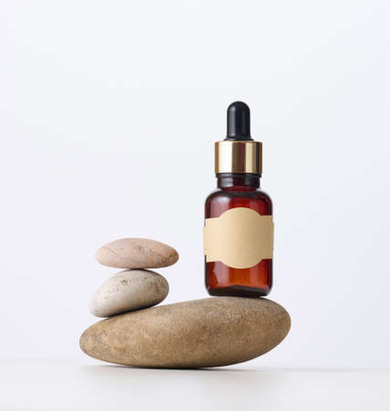 brown glass bottle with a pipette on a white background. Template for cosmetic liquid products, advertising and promotionの写真素材