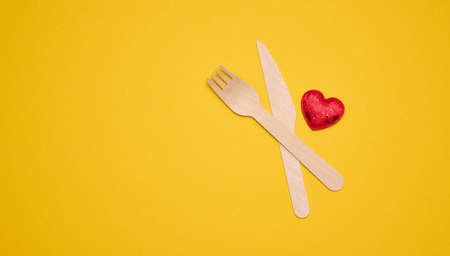 disposable fork and knife on a yellow background, eco utensils. Zero Wasteの写真素材