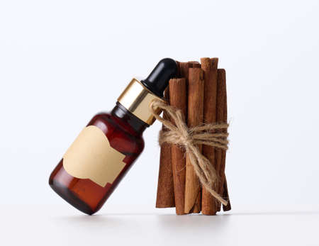 brown glass bottle with paper empty label and pipette. Cosmetic packaging, advertising and promotionの写真素材