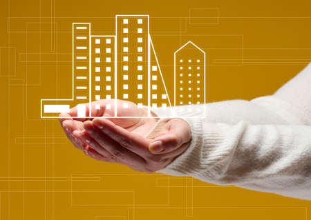 two female palms and house icon on yellow background. Real estate insurance concept, property protectionの写真素材