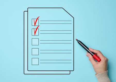 a female hand holds a red market and a document with cells for marking on a blue background. Voting...