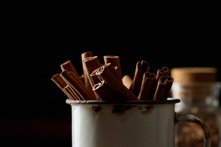 dry brown cinnamon sticks in a metal old mug, culinary spiceの写真素材