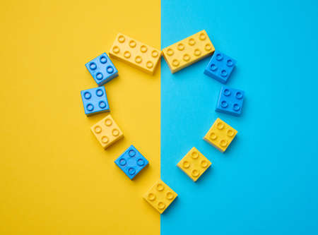 Plastic yellow-blue details of the children's designer in the shape of a heart. Children's...