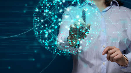 Female hand touches the global virtual network of the globe. Information exchange, communication and...