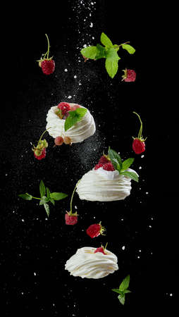 Baked cake made from whipped chicken protein and cream, decorated with fresh berries. Dessert levitates on a black backgroundの写真素材