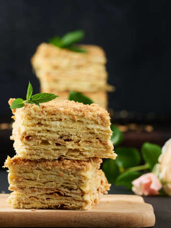 A stack of baked Napoleon pie slices with cream. Puff pastry, delicious dessertの写真素材