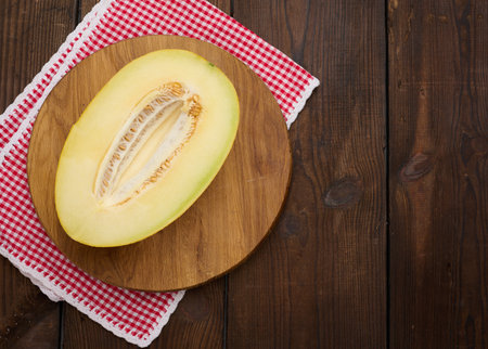 Half of ripe melon on round wooden boards, top viewの写真素材