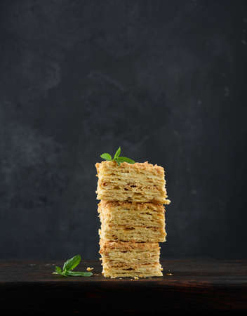 A stack of baked Napoleon pie slices with cream. Puff pastry, delicious dessertの写真素材