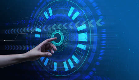 Virtual start button on the holographic screen, starting a business and a new life. Running a program with a female handの写真素材